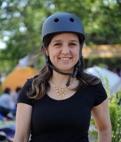 Zeynep Tufekci smiling and wearing a helmet during the 2013 Istanbul protests